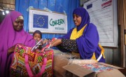 Naima, Concern Nurse dispensing Plumpy Nut to mother Hani at OTP Centre. Somalia. Photo: Mohamed Abdiwahab/Concern WW
