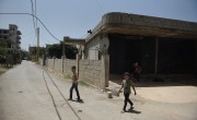 Syrian refugee *Dibeh and her children leave the garage where they are currently living. Photo: Mary Turner 