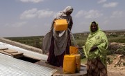 Women collect water from an underground tank. Photo: Eamon Timmins/Concern Worldwide