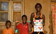 Shyreen with her sons Ramsy and Leonard after receiving soap and Covid-19 fliers from Concern.