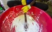 Smeralda Guerrier a beneficiary of Concern readies liquid soap in Cite Soleil slum a district of Port-au-Prince Haiti