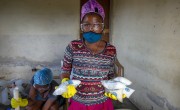 Sterline Dieu pictured as she holds up salts while they are making liquid and solid soap in Cite Soleil slum, Haiti. Photo: Dieu Nalio Chery
