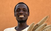 Mika Abdu proudly displays some of his short-season millet crop, grown from seeds supplied by Concern. Photo: Darren Vaughan/Concern Worldwide