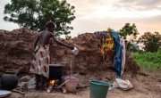 Concern staff visit a family at their rented house in Pouytenga Centre East where they have no toilets. They are preparing corn meal for their dinner. Photo: Anne Mimault/Concern Worldwide