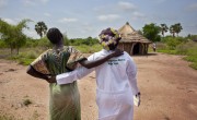 Chagawa* who is 9 months pregnant stands in front of a Mobile Health Clinic in a remote rural area of Aweil, South Sudan. With her is Concern midwife Rebekka. Photo: Abbie Trayler-Smith