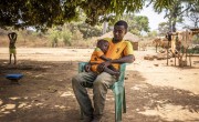 Alain* (46) and baby Christian* (19 months old) in Ngata village outside their home. Photo: Ed Ram/Concern Worldwide