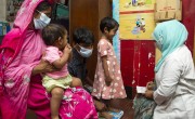 Asmaul Hosne Ara and her husband Mohammad Masum take their two children for a check-up by a nurse at a Concern run pavement dweller centre in Dhaka, Bangladesh. Photo: Emdadul Islam Bitu/Concern Worldwide