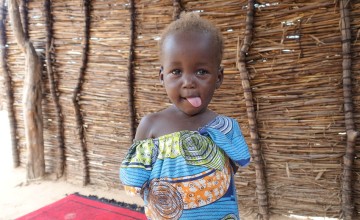 Khamissa Ibrahim is 32 years old mother of six. Pictured is little Rafaida (1). Khamissa is a Concern-trained Community Health Volunteer. She also sells onions, salt, garlic, oil, okra and chili. Concern’s support has greatly benefited Doroti village as there are less child and adult illnesses. There is a lower rate of malnutrition in women and children. Chad. Photo: Lucy Bloxham/ Concern Worldwide
