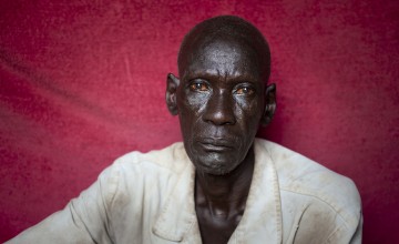 Nasil* lives with his brother Gatlit* in one room with their children. Photo: Abbie Trayler-Smith
