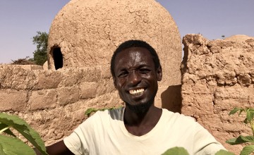 Mika Abu with his vegetable sacks full of amaranth leaves. Photo: Darren Vaughan/Concern Worldwide