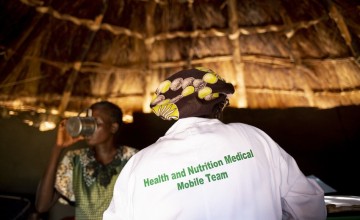 Concern midwife Rebekka at a Mobile Health Clinic in a remote rural area of Aweil, South Sudan. The mobile clinic visits five locations once a week. In the picture Rebekka is seeing Chagawa* (28) who is visiting for a check up as she is 9 months pregnant with her ninth child. Photo: Abbie Trayler-Smith/ Concern Worldwide