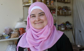 Bushra runs a small grocery shop near the tented settlement where she lives. Photo: Darren Vaughan