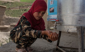 Beta* washes her hands at the newly installed water station. Photo: Stefanie Glinski