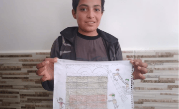 12-year-old Abdallah from Syria pictured here with his drawing of what he wants to be when he grows up: an architect.