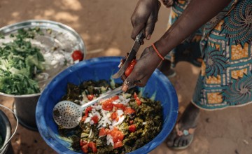 A community cooking demonstration with vegetables grown in home gardens