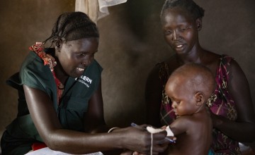 Concern Health Worker Rebekah visits Nyariemi and her eight-month-old son, Parnath, who is being treated for Severe Acute Malnutrition in their home in the Pugnido refugee camp, Ethiopia. Photo: Kieran McConville
