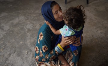 Syrian refugee *Nofah holds her daughter *Alya, in Lebanon. Photo: Mary Turner