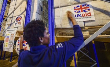 A woman prepares to send a shipment of suppoprt provided by UK aid