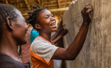 Patience teaches women the alphabet in Manono, Tanganyika. Photo: Pamela Tulizo/ Panos Pictures