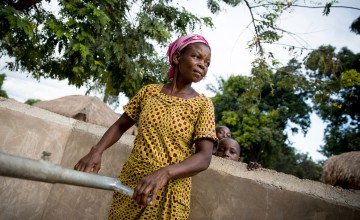 49-year-old Gisele draws water from a pump installed in the village of Pension, Manono Territory, as part of our Graduation Programme. Alongside targeted trainings and cash transfers, Concern Worldwide focuses on developing the region through the provision of water and hygiene facilities. Photo: Hugh Kinsella Cunningham