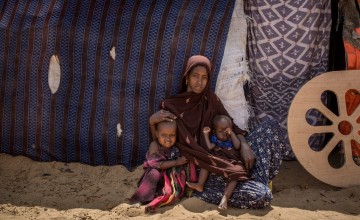 Naima* with her children outside their hut at in an IDP site in Somalia. Photo: Mustafa Saeed