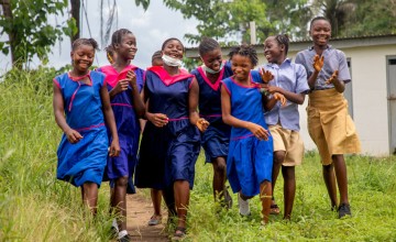 Aminata, 15,  and her fellow pupils beside the Girls toilets of Benevolent Islamic PRI School in Yele town.