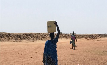A woman in South Sudan collects water. Concern is providing clean water to thousands of people in Unity through a combination of surface water and boreholes. Photo: Susan Finucane/Concern Worldwide