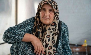 Farhana* inside her tent at a camp in northwest Syria. As part of our DEC funded response to the Syria-Turkey earthquakes, cash assistance is distributed to displaced families living in camps and temporary shelters to meet their immediate basic needs. 