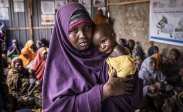 Mother holds baby in a clinic