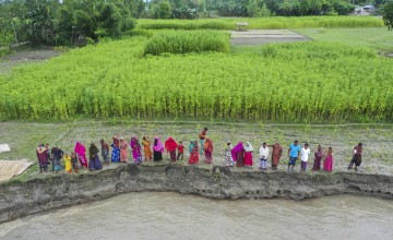 For the community of Vati Kapasia, Sundarganj, life is a relentless struggle against the constant threat of losing homes and croplands to riverbank erosion, followed by the challenge of relocating to areas further from the river's edge. This char, a river basin area along the Teesta River in Sundarganj, stretches across Gaibandha to meet the mighty Brahmaputra. Photo: Saikat Mojumder/Concern Worldwide