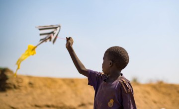 A child flies a home-made kite in a PoC camp in Juba, South Sudan. Photo: Steve De Neef / Concern Worldwide.