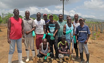 Ebola burial teams return to Waterloo cemetery to help with the graves of the hundreds of people lost in the recent mudslides. Photo: Kristin Myers