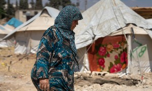 Shahinaz* walks through a camp in north-west Syria on 22 June 2023. As part of Concern Worldwide’s response to the Syria-Turkey earthquake, cash assistance is distributed to displaced families living in camps and temporary shelters to meet their immediate basic needs. After an informational session, each household receives a cash voucher at the distribution point.