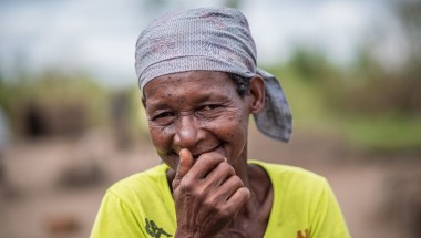Joana Luis, 65, photographed with her family&#039;s pile of supplies received at a distribution in Ndeja, Mozambique. Photo: Tommy Trenchard