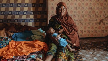 A mother breastfeeds her young baby
