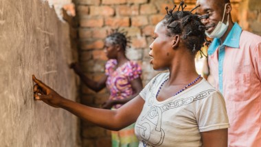 A woman does an exercise on the board at one of Concern’s projects in Manono, Tanganyika for illiterate women. Photo: Pamela Tulizo/Panos/Concern Worldwide
