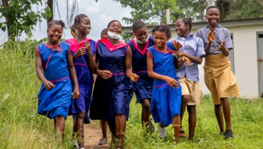 Aminata, 15, and her fellow pupils beside the Girls toilets of Benevolent Islamic PRI School in Yele town.