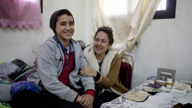 Rabia, a member of the Concern-funded sewing workshop in Tripoli, Lebanon, with her son. Credit: Abbie Traylor-Smith/Panos for Concern Worldwide