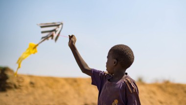 A child flies a home-made kite in a PoC camp in Juba, South Sudan. Photo: Steve De Neef / Concern Worldwide.