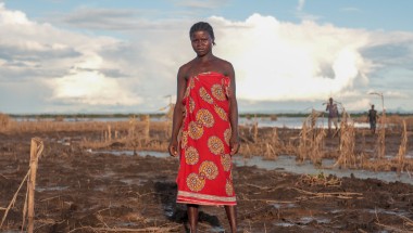 Farmer Malita (25) inspects what&#039;s left of her field after extensive flooding. The entire crop has been ruined just one month before harvest. Photo: Gavin Douglas/Concern Worldwide.
