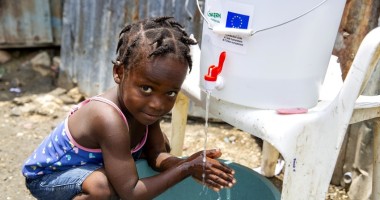 Cherica (2) washes her hands in front of her grandmother's home in Cite Soleil, a district of Port-au-Prince, Haiti. Photo: Dieu Nalio Chery/ Concern Worldwide