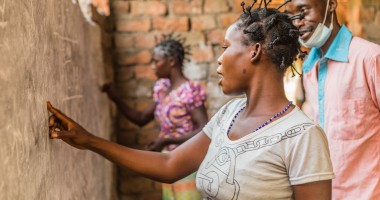 A woman does an exercise on the board at one of Concern’s projects in Manono, Tanganyika for illiterate women. Photo: Pamela Tulizo/Panos/Concern Worldwide
