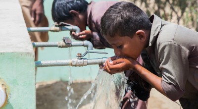 Children from Satla Bheel village enjoy drinking water from the water plant system installed by Concern. Pakistan. Photo: Black Box Sounds/Concern Worldwide