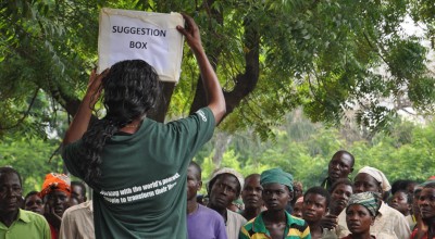 Victoria Mwanjabe, Concern staff, explain to people dispaced by flooding how they can give feedback about Concern's work at a camp in Nsanje District. Photographer: Deborah Underdown/Feb 2015/Malawi