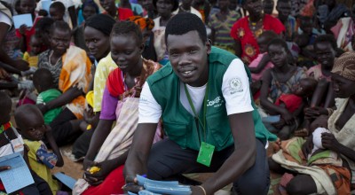 The community gathers for a Concern Worldwide Nutrition clinic at a health facility in a rural area of Aweil, South Sudan. Concern Nutrition Assistant Simon is pictured leading an educational session. Photo: Abbie Trayler-Smith