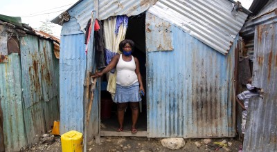 Louismene pictured outside the home she shares with her children four children in Cite Soleil slum, a district of Port-au-Prince, Haiti. Photo: Dieu Nalio Chery