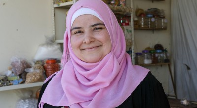 Bushra runs a small grocery shop near the tented settlement where she lives. Photo: Darren Vaughan