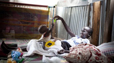 Dehlia* with her sister Koaloch* hang out in the mother and baby room in the Concern Nutrition Clinic in a POC in Juba, South Sudan. Photo: Abbie Trayler-Smith