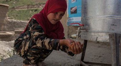 Beta* washes her hands at the newly installed water station. Photo: Stefanie Glinski