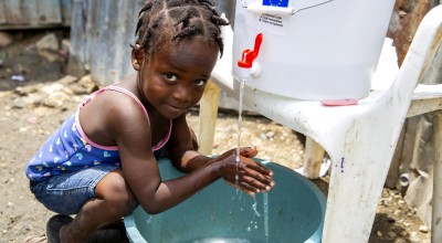 A girl washes her hands 